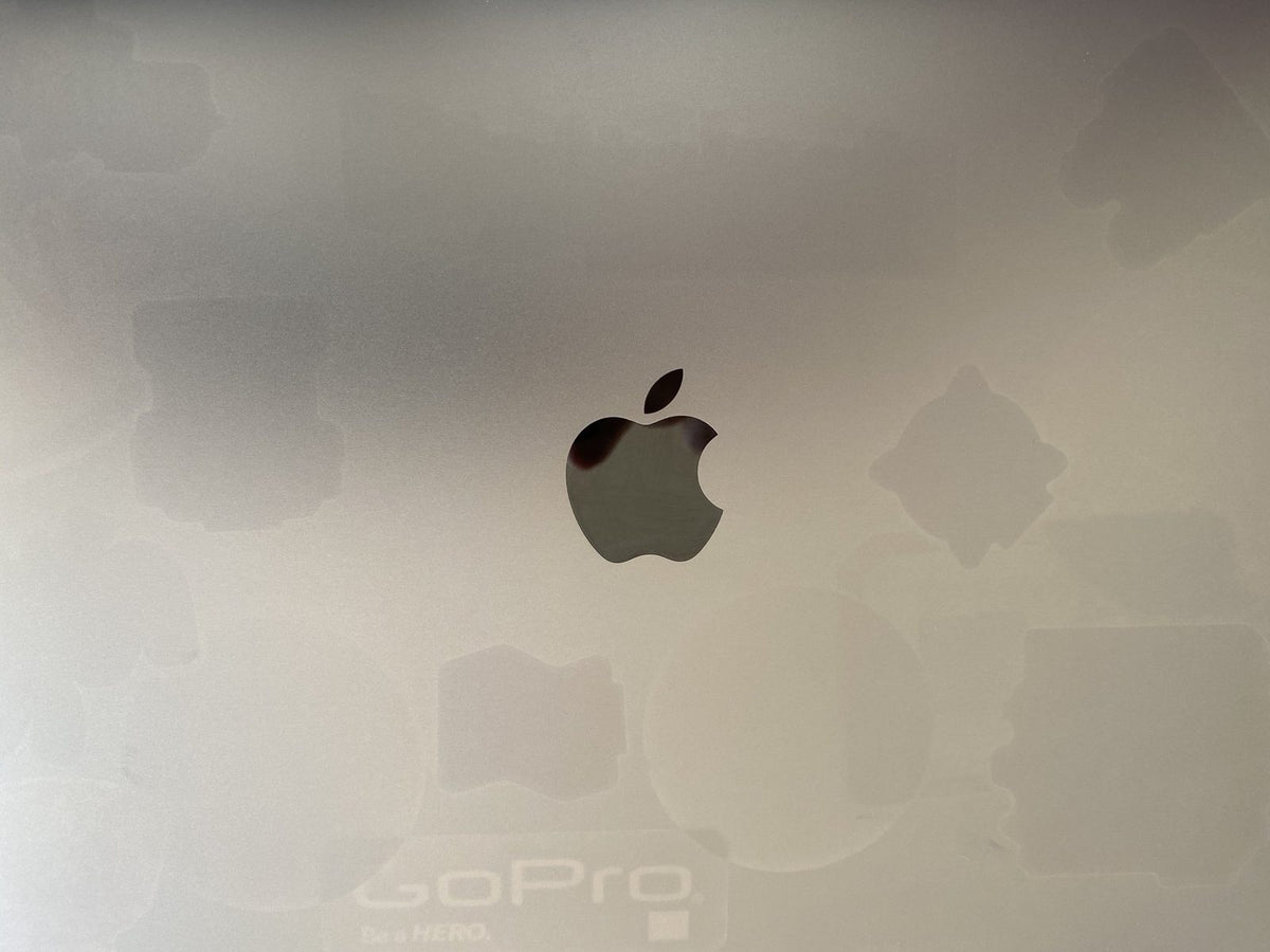 A MacBook lid after the stickers were removed and the surface cleaned